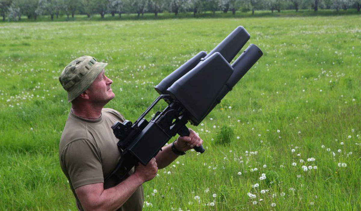 A Ukrainian soldier displays an anti-drone rifle in Kyiv